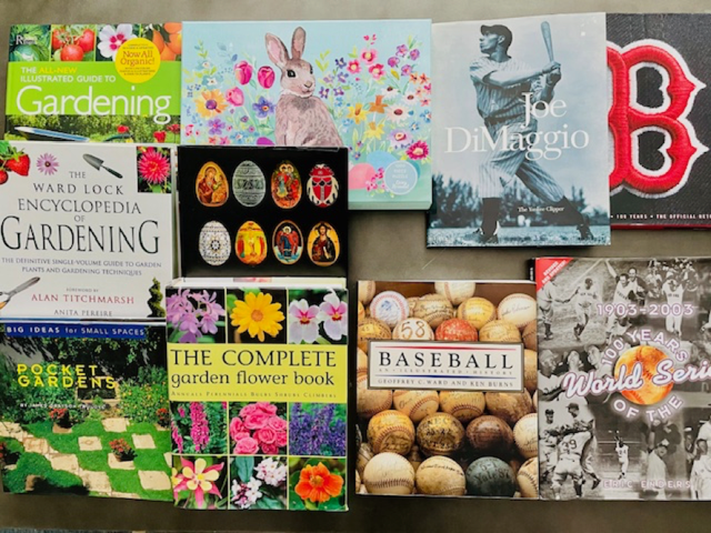 The Friends' book auction table. Titles include "The All-New Illustrated Guide to Gardening", "Joe DiMaggio", "The Ward Lock Encyclopedia of Gardening", "Pocket Gardens", "The Complete Garden Flower Book", "Baseball: an Illustrated History", and "1903-2003: 100 Years of the World Series".