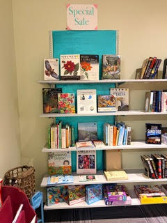 The special book sale shelves. Books about birds and gardening are displayed face-out.